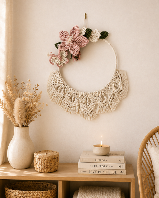 Handmade floral macrame wall hanging with pink flowers and butterfly styled in a boho interior