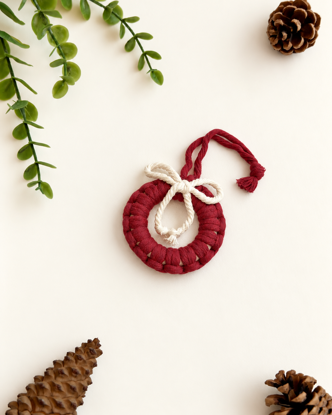 Burgundy macrame Christmas wreath ornament with cream bow