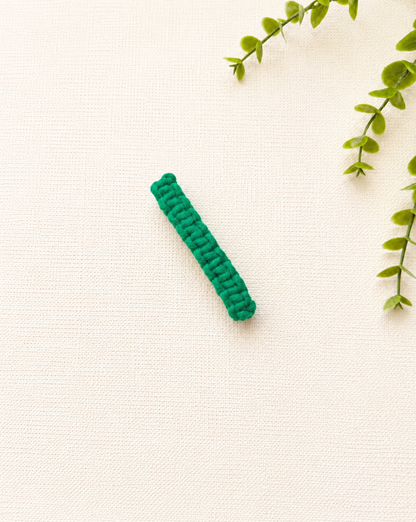 Green handmade macramé hair clip with woven macramé pattern