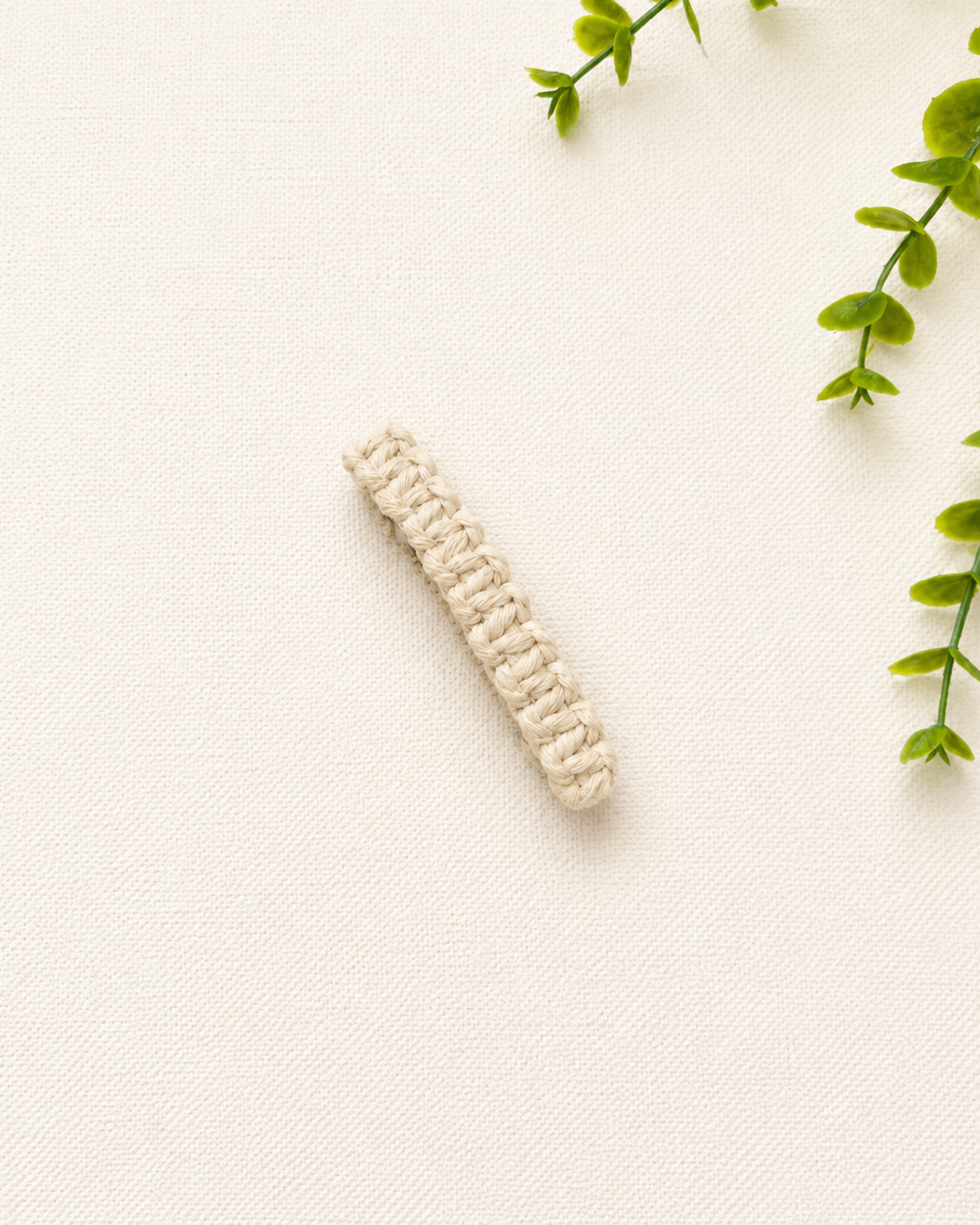 Off-white handmade macramé hair clip with woven cotton knot design
