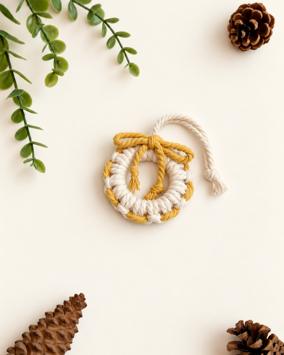 Cream macrame Christmas wreath ornament with mustard yellow bow