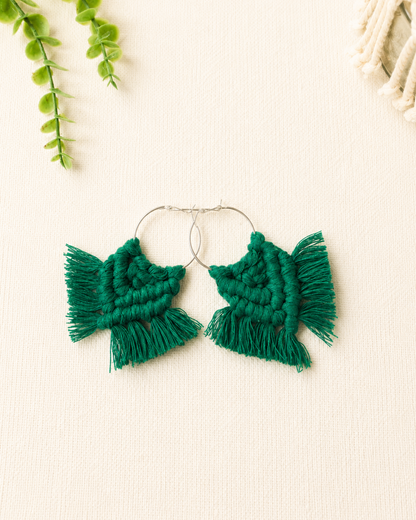 Handmade emerald green macrame chevron hoop earrings with silver hoops and cotton fringe.