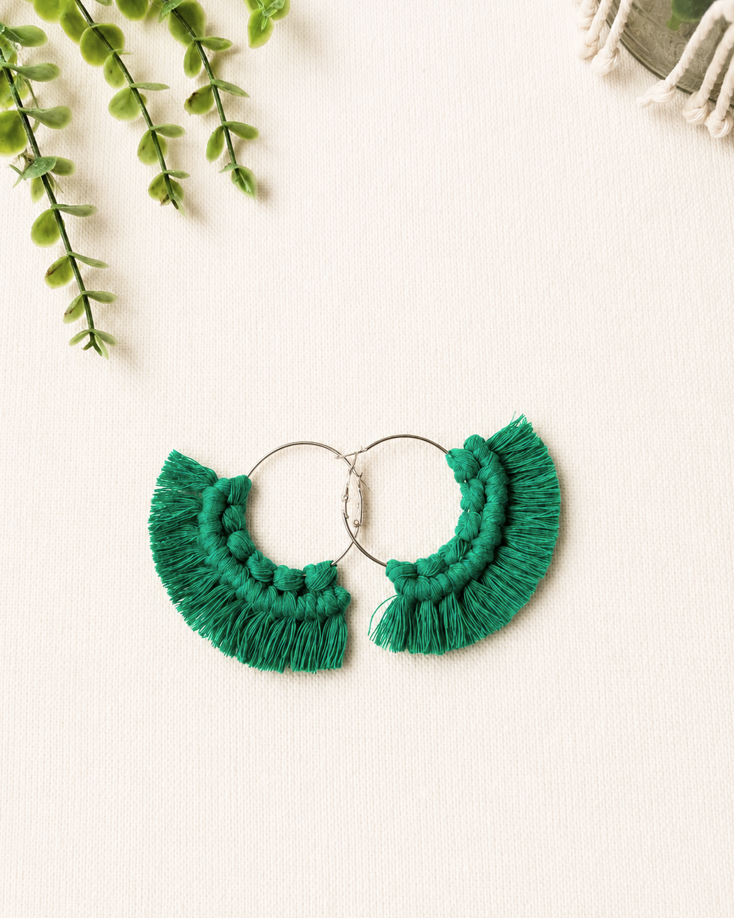 Handmade emerald green macrame fringe hoop earrings with stainless steel hoops.