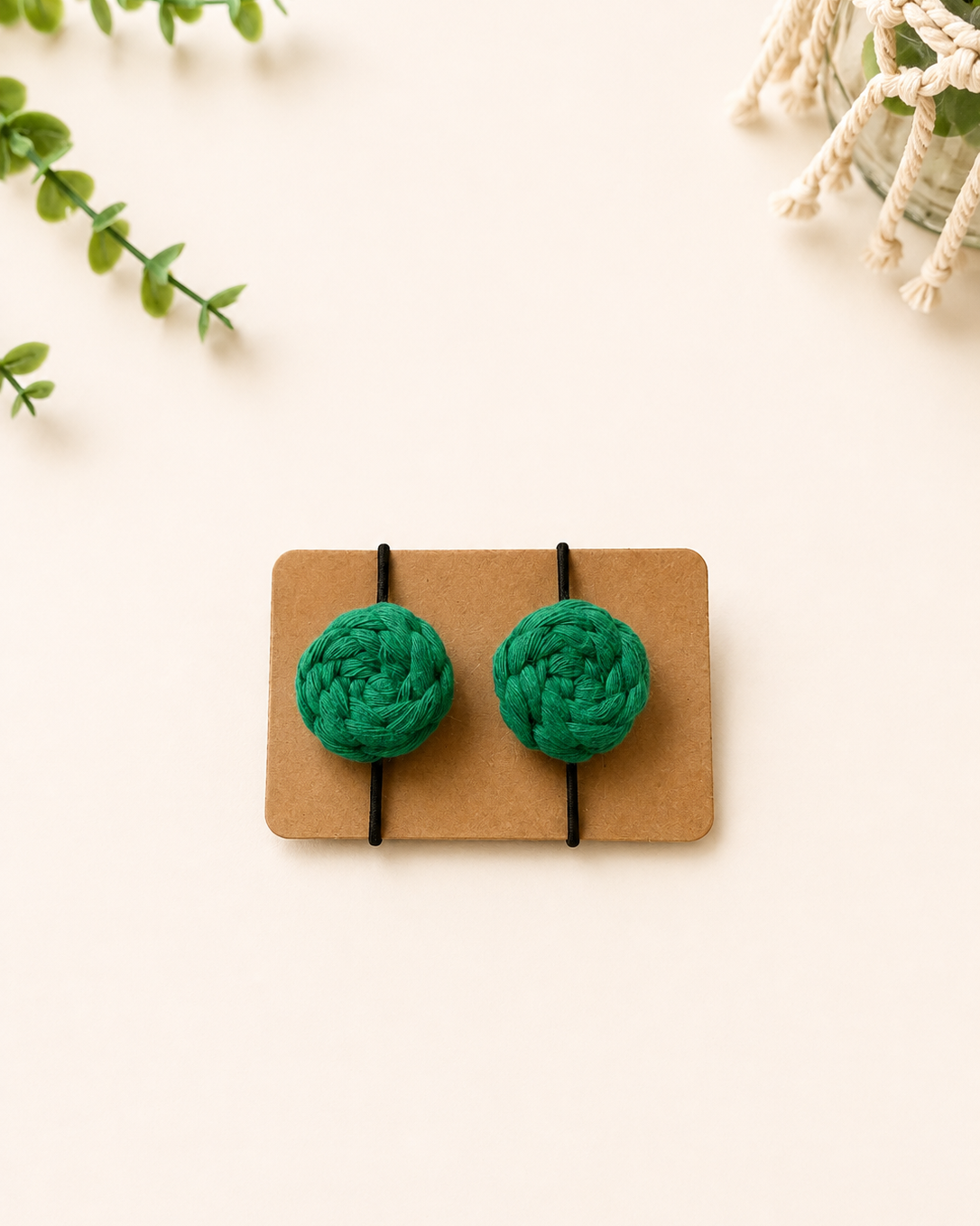 Emerald green handmade macrame cotton hair ties with black elastic bands.