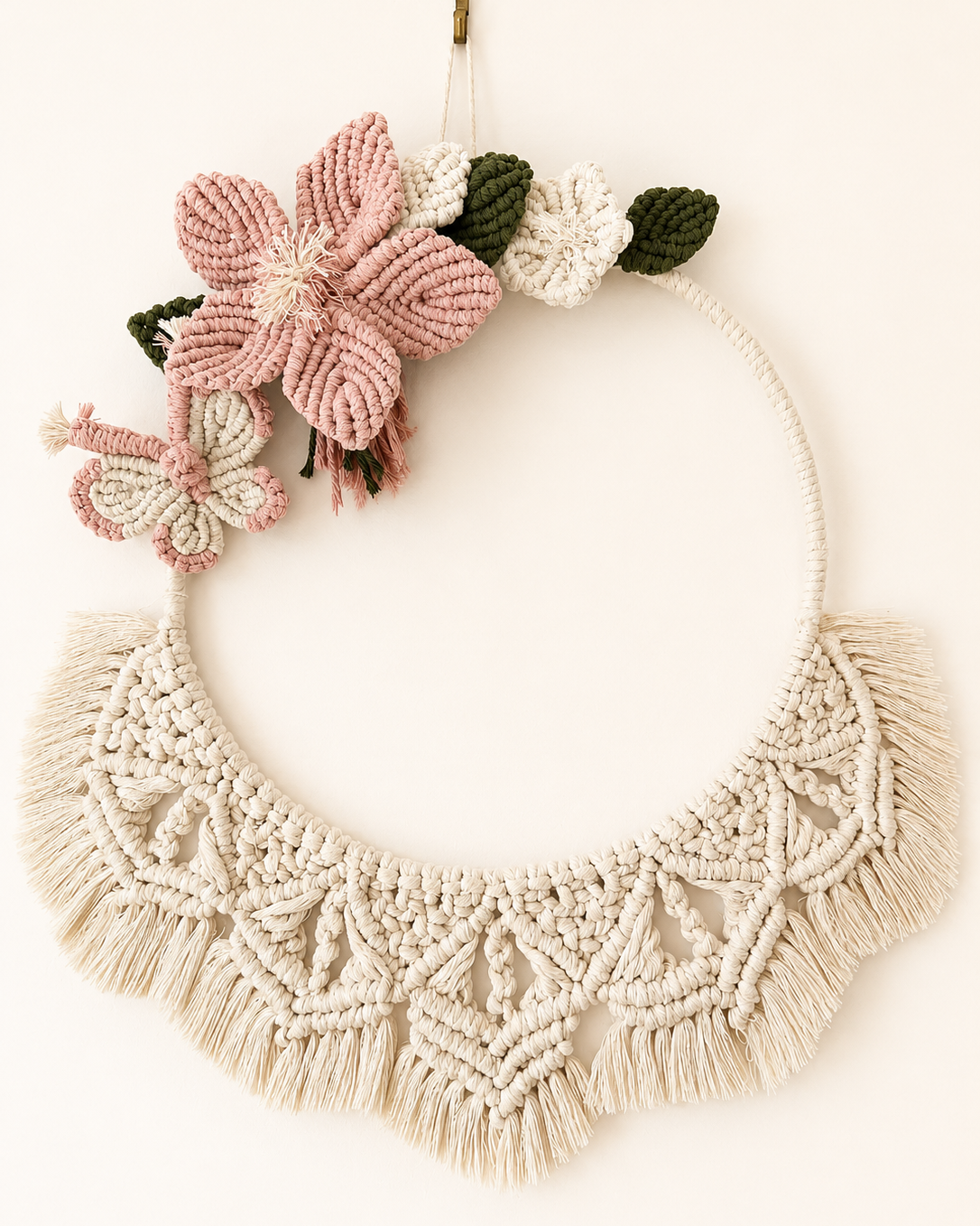 Handmade floral macrame wall hanging with pink flower, butterfly and fringe