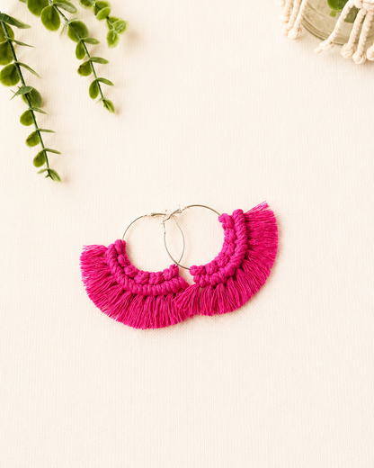 Handmade fuchsia macrame fringe hoop earrings with stainless steel hoops.