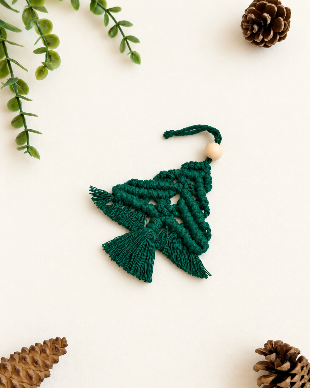 Green handmade macrame Christmas tree ornament with natural wooden bead