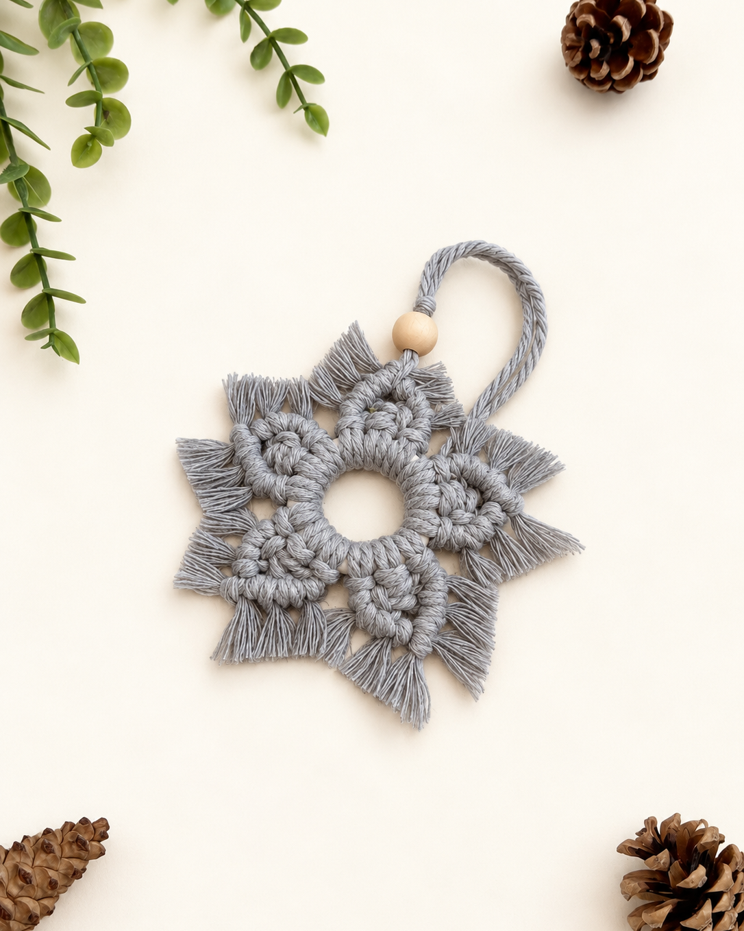 Handmade grey macrame snowflake Christmas ornament with wooden bead