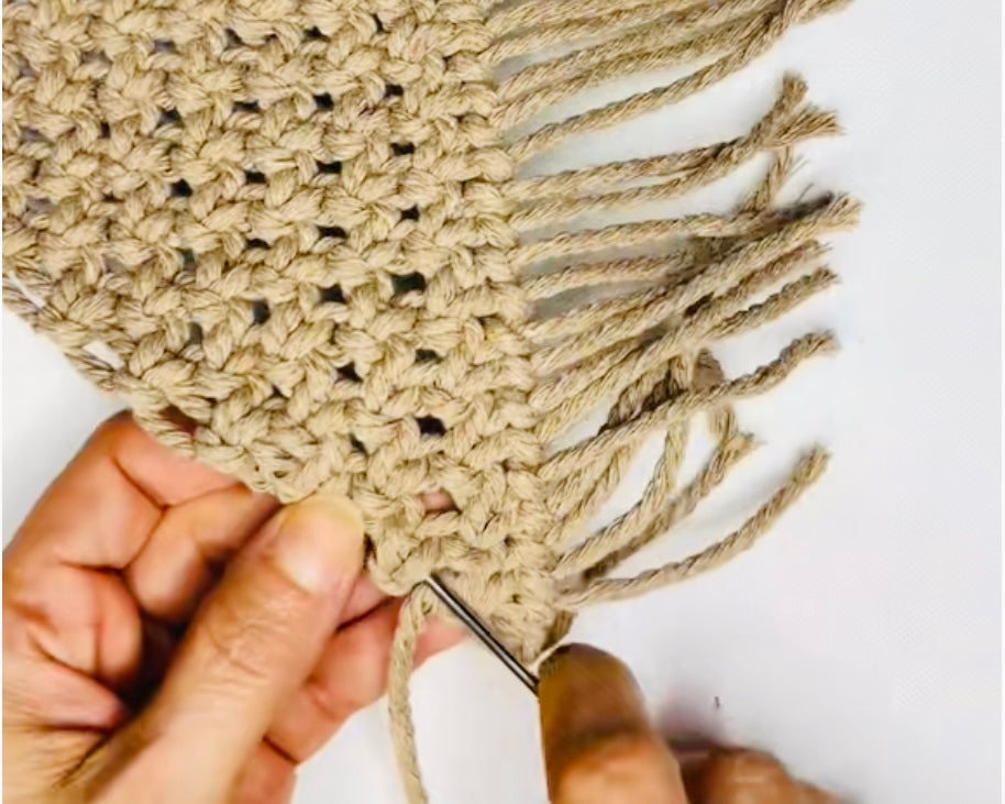 Hand finishing a macrame piece by Samra Knots