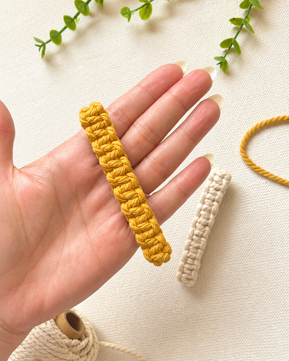 Hand holding macramé hair clips to show size and scale of the 8cm clip