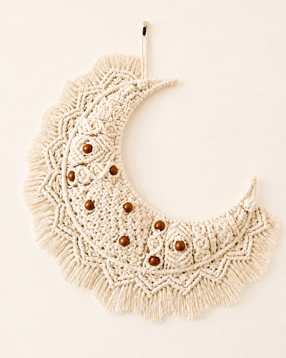 Handmade macrame crescent moon wall hanging in off-white Egyptian cotton with brown wooden beads