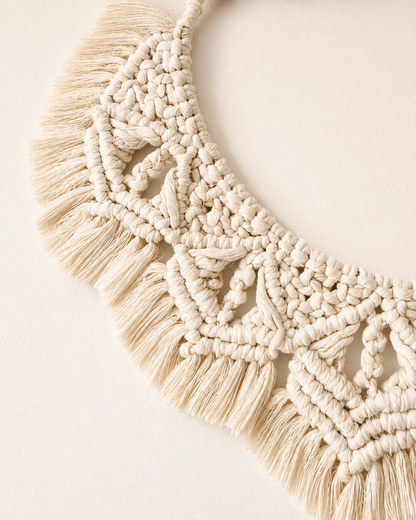 Detailed handmade macrame wall art with decorative knots and natural cotton fringe