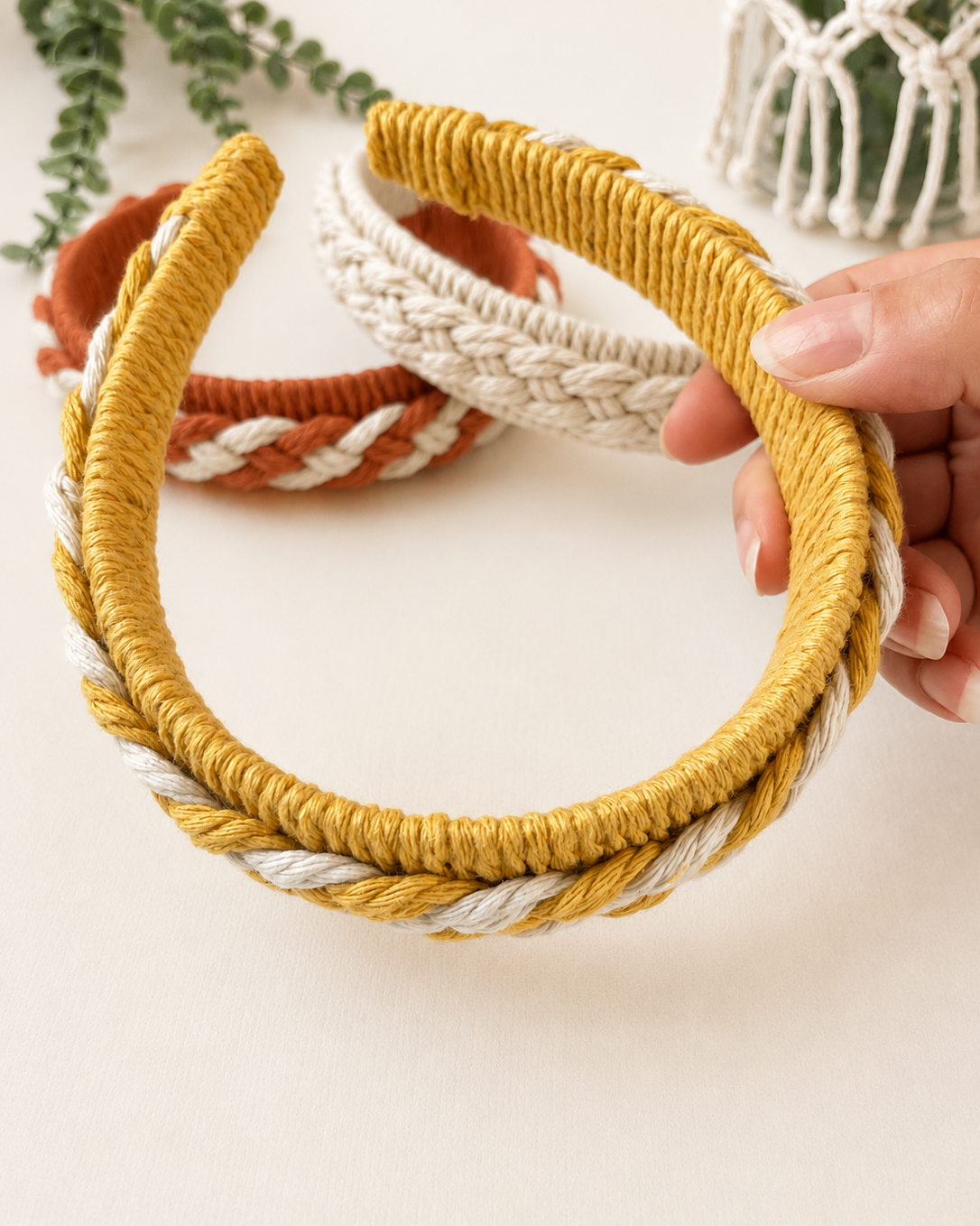 Back view of a handmade macrame headband showing the wrapped cotton finish