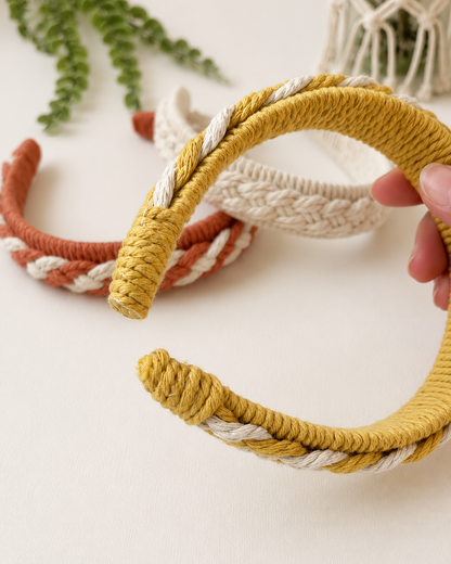 Side view of a handmade macrame headband showing the braided detail