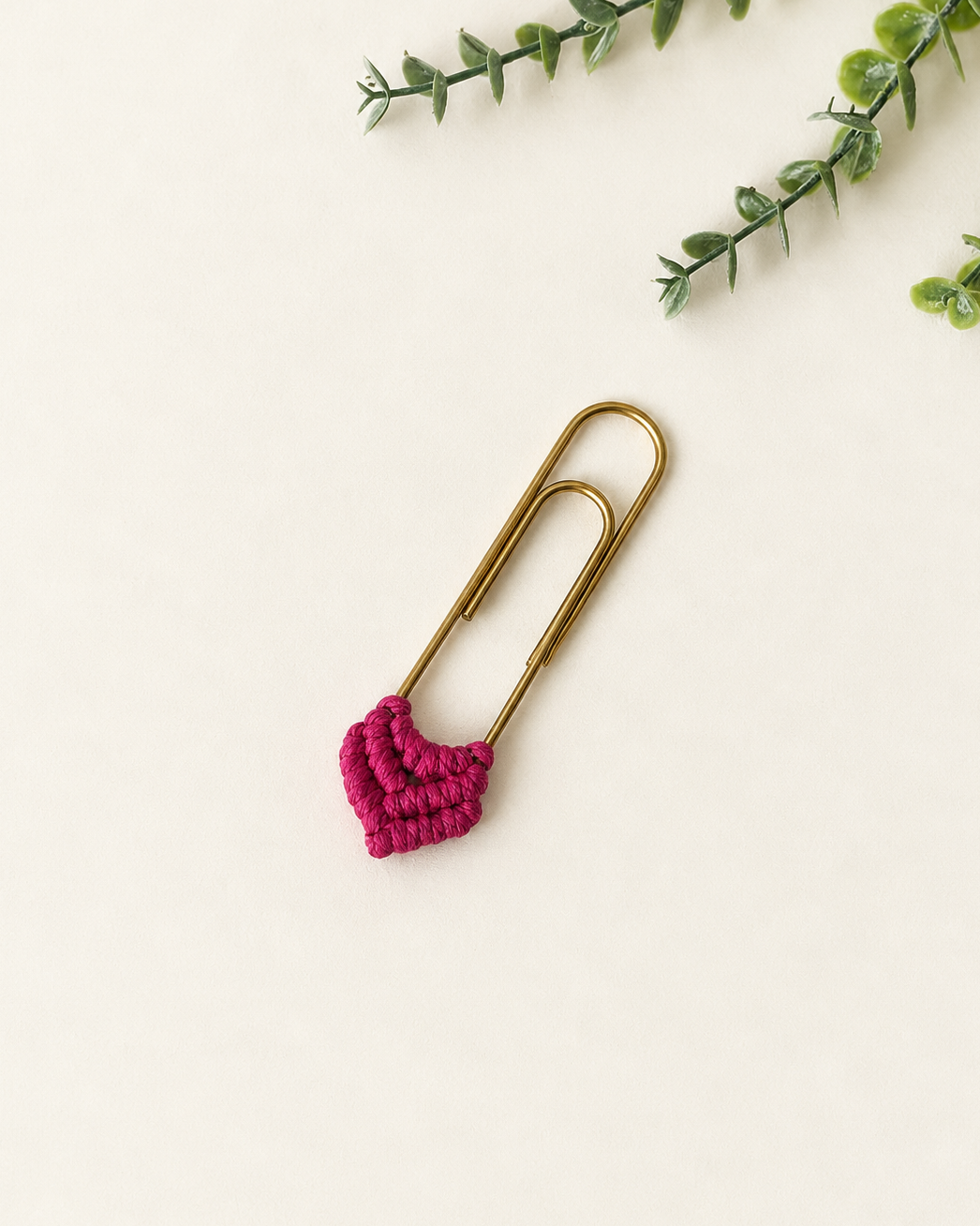 Hot pink handmade macramé heart bookmark with gold paper clip