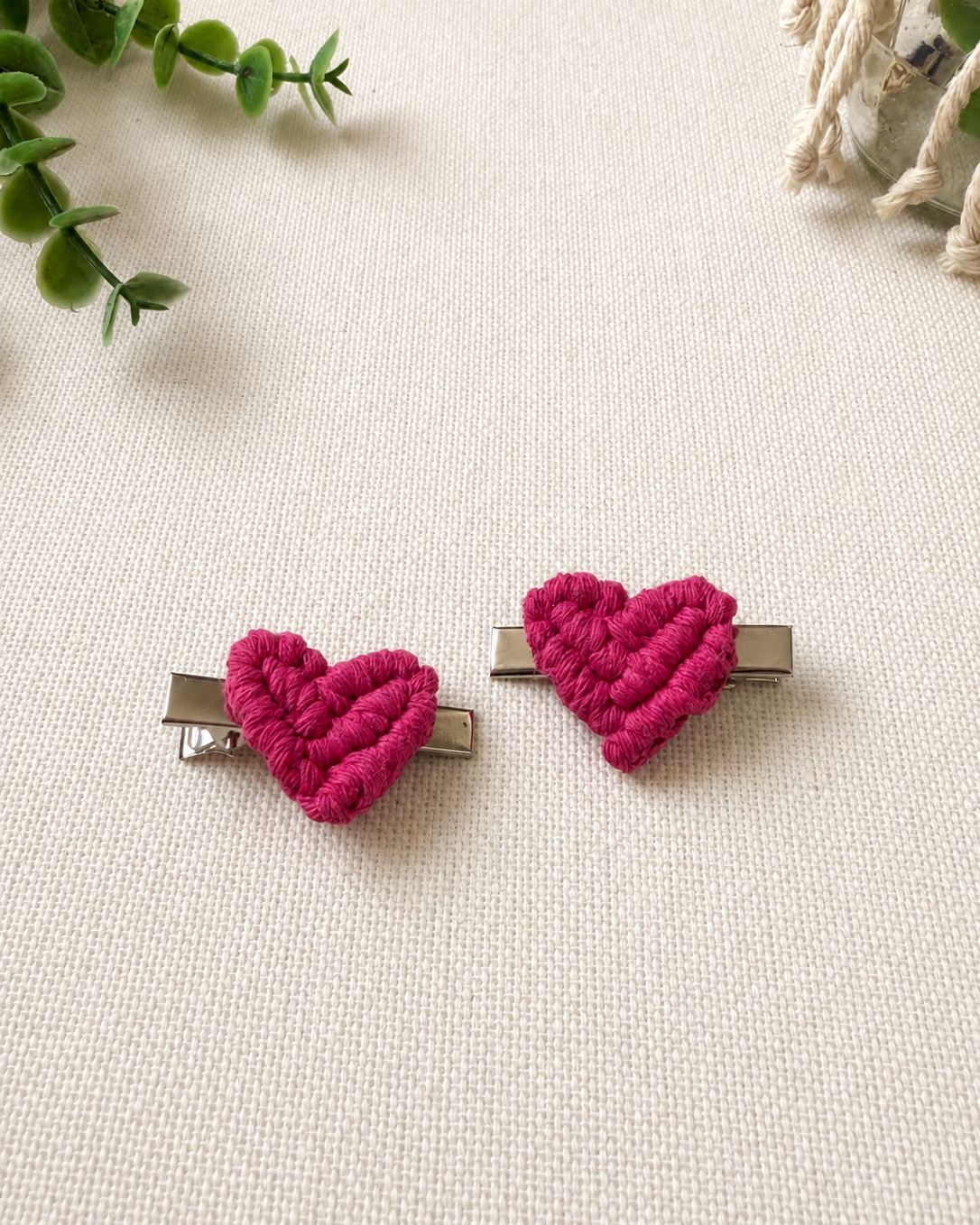 Set of two hot pink handmade macrame heart hair clips.