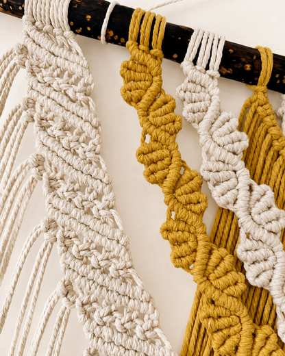 Close-up of the layered macrame wall hanging showing intricate knotwork and natural driftwood details.
