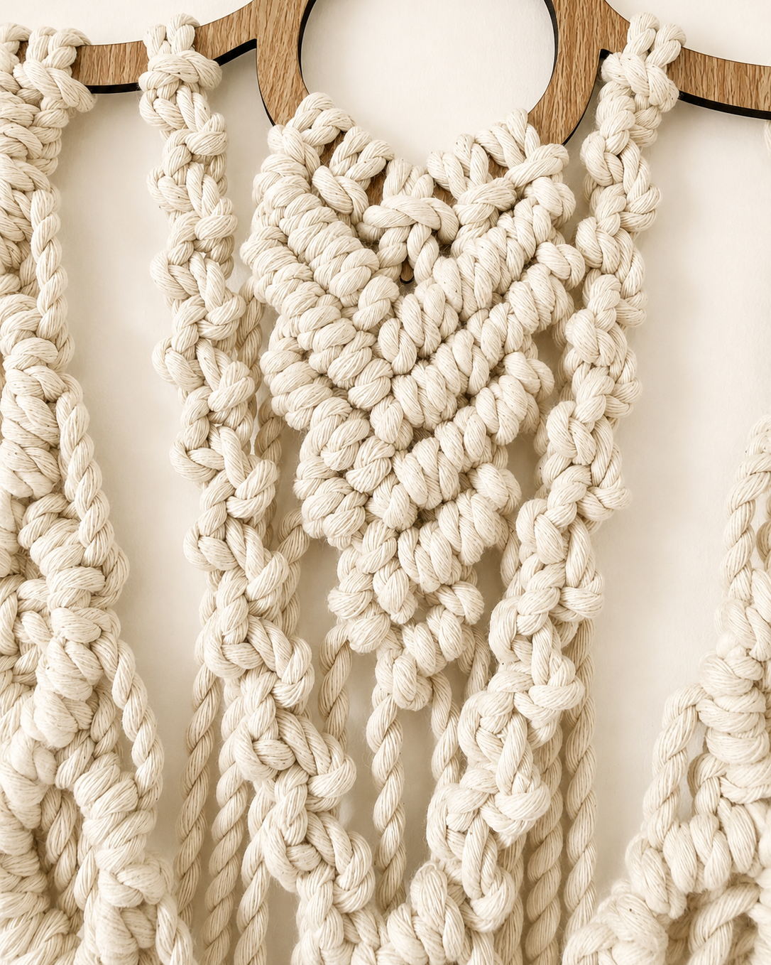 Close-up of the centre chevron knot pattern on the handmade lotus macrame wall hanging.