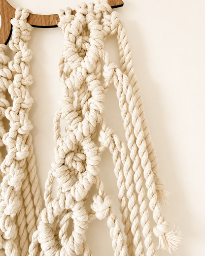 Close-up of twisted cotton fringe and knotwork on the lotus macrame wall hanging.