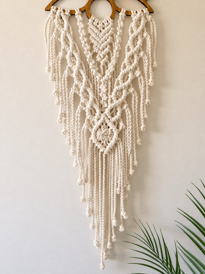 Full view of handmade lotus macrame wall hanging showing intricate knotwork and long fringe.