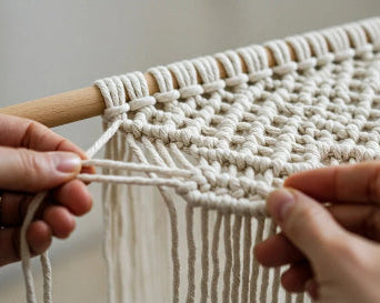 Close-up of a handmade macramé weaving process, showcasing artisanal craftsmanship.