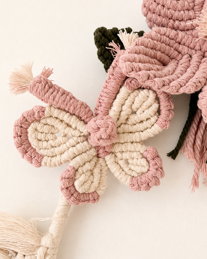 Handmade pink and natural cotton macrame butterfly detail on wall hanging