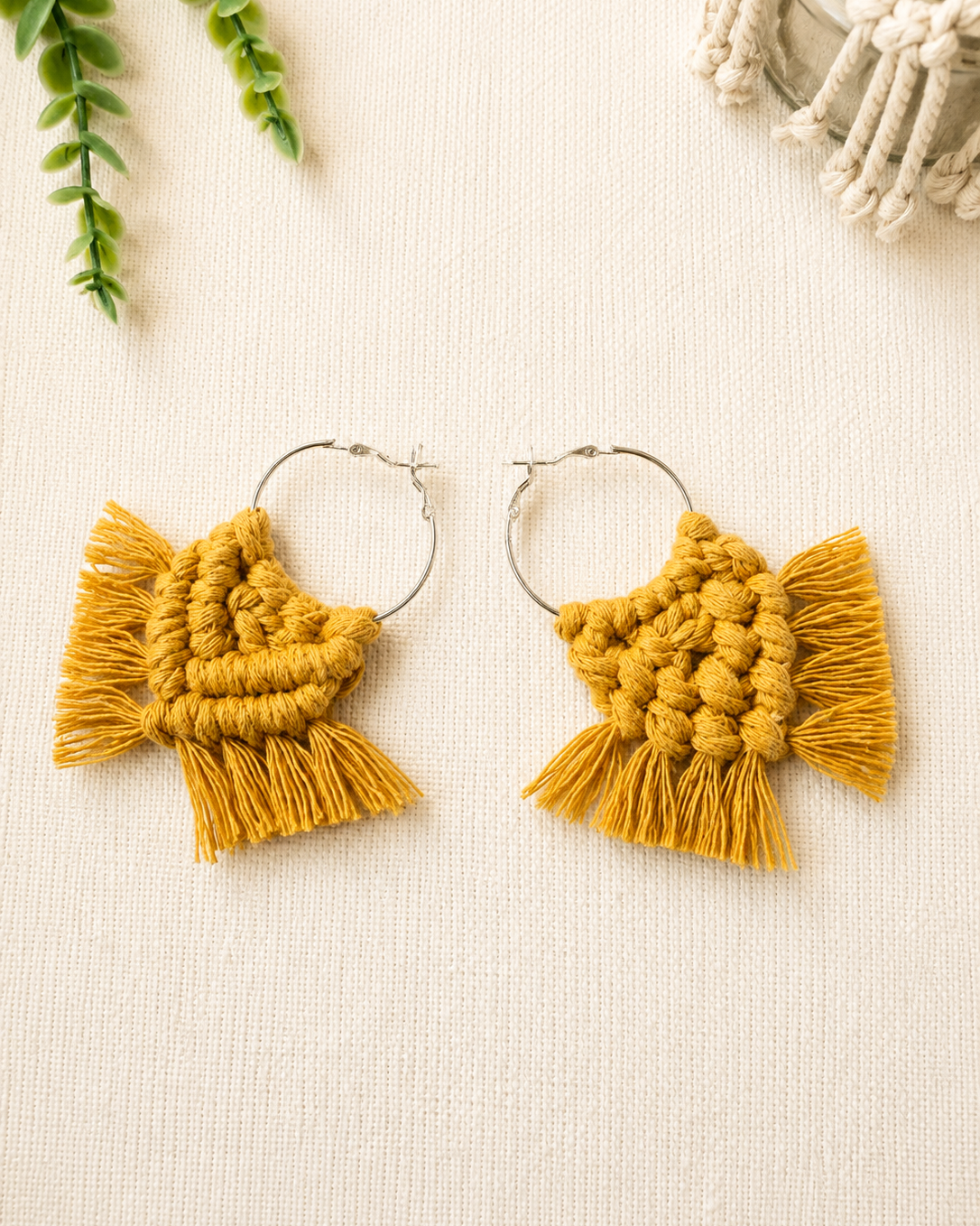 Front and back view of handmade macrame chevron hoop earrings showing the knotwork and silver hoop finish.