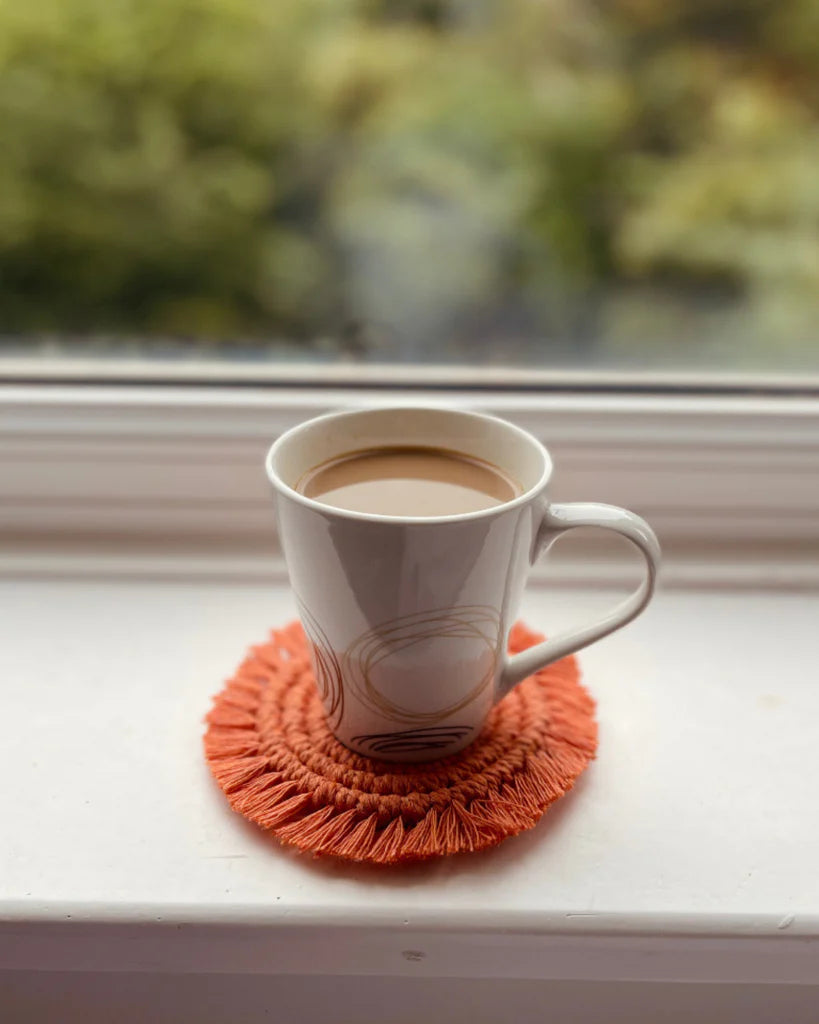 Handmade terracotta macramé coaster with coffee mug