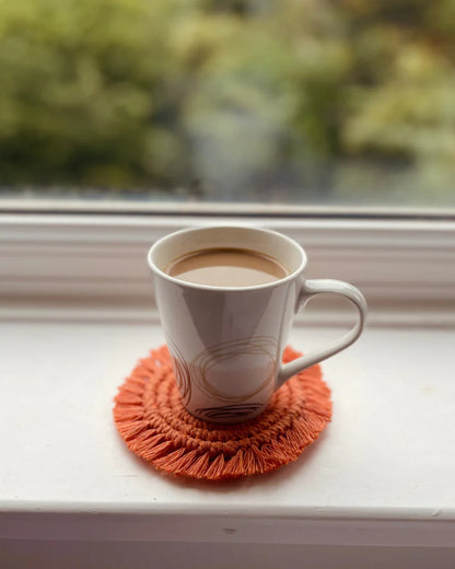 Handmade terracotta macramé coaster with coffee mug
