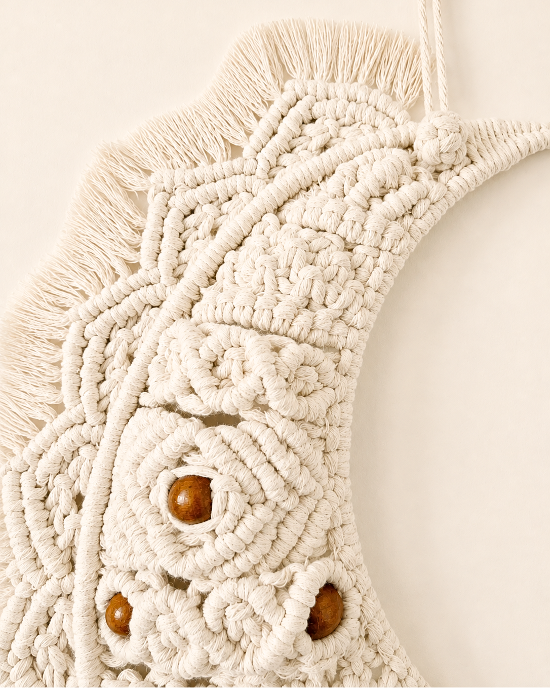 Close-up of detailed knots on handmade Egyptian cotton macrame crescent moon wall hanging