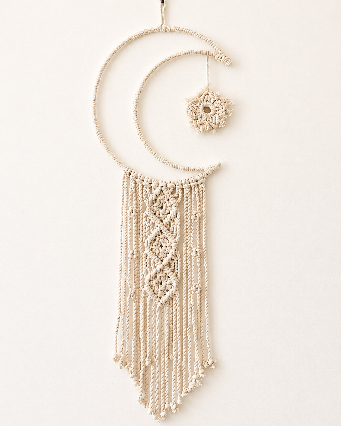 Handmade macrame crescent moon wall hanging with geometric knotted design