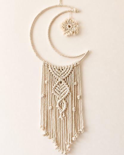 Handmade macrame crescent moon wall hanging with textured central knot design