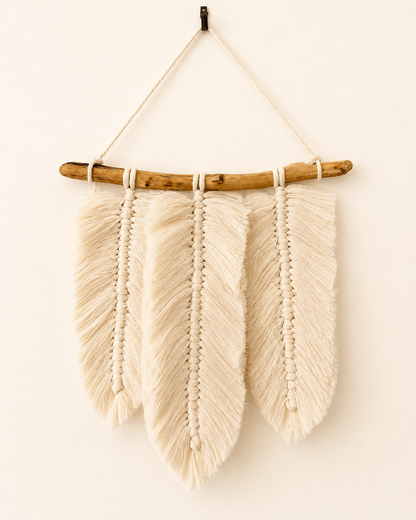 Handmade macrame feather wall hanging with three Egyptian cotton feathers on a natural wood branch