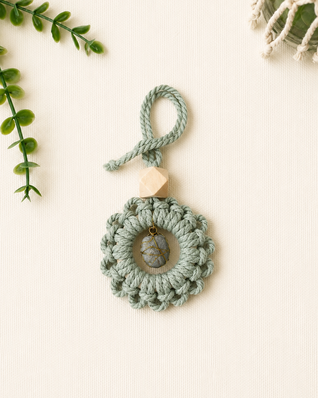 Handmade sage green macrame gemstone car charm with a natural unfinished wooden essential oil diffuser bead.