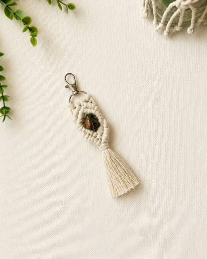 Handmade green and orange macrame gemstone keychain with a natural gemstone, cotton tassel and silver clasp.