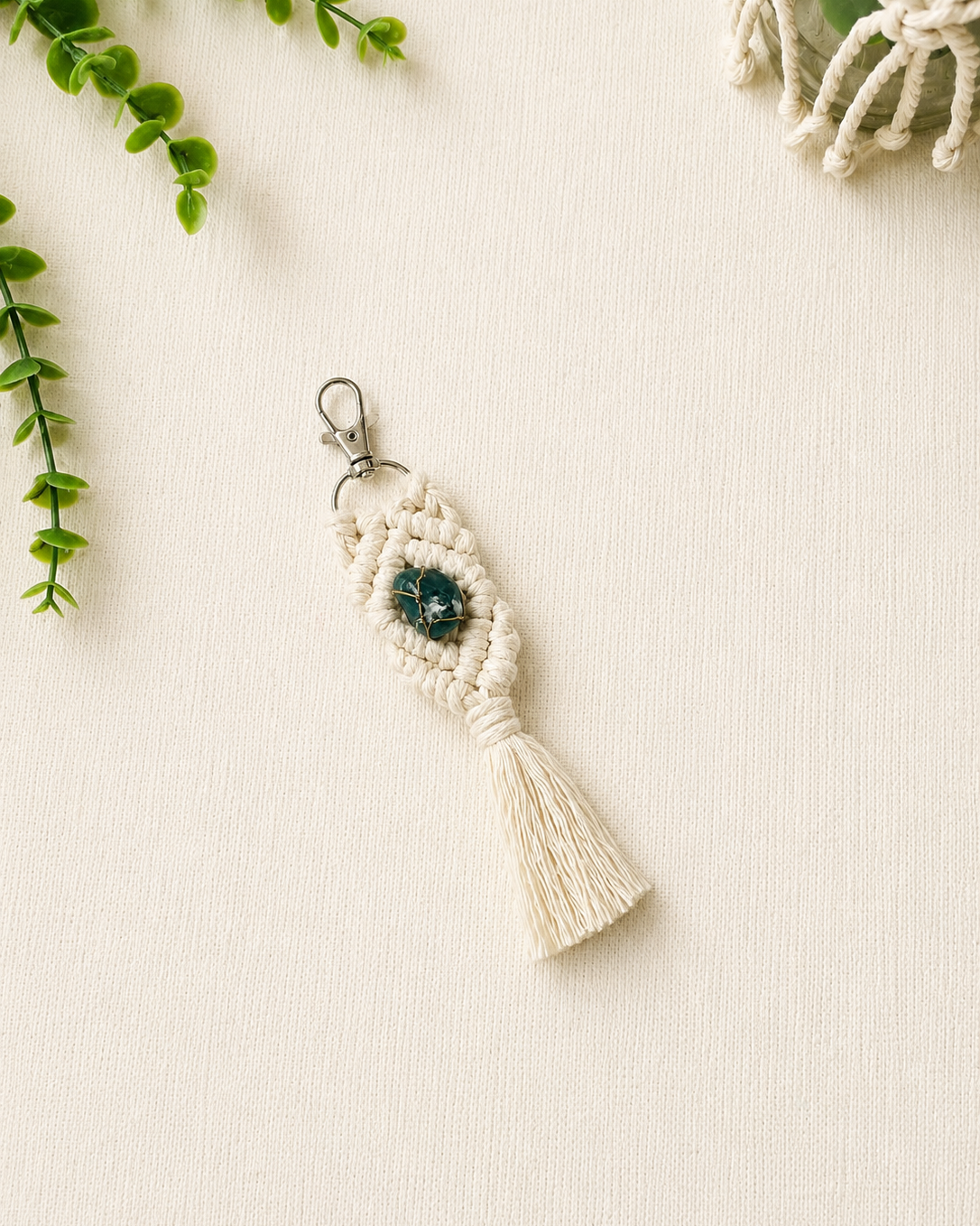 Handmade green macrame gemstone keychain with a natural gemstone, cotton tassel and silver clasp.
