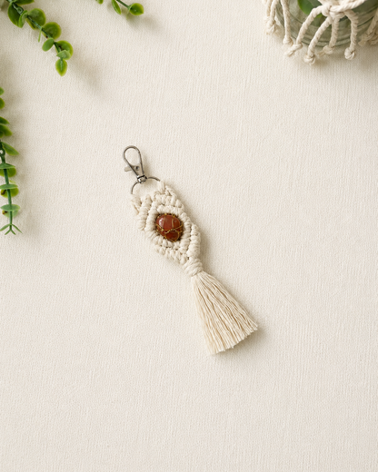 Handmade orange macrame gemstone keychain with a natural gemstone, cotton tassel and silver clasp.