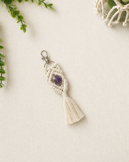 Handmade purple macrame gemstone keychain with a natural gemstone, cotton tassel and silver clasp.