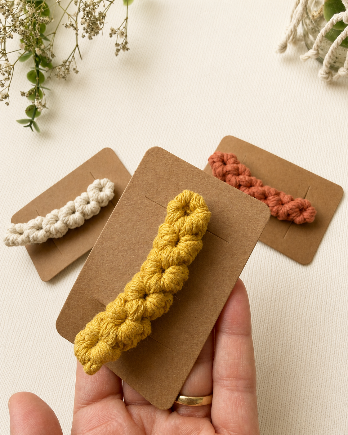 Handmade macrame hair clip presented on a kraft display card.