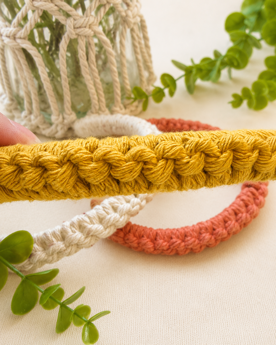 Close-up of handmade cotton macramé headband showing knot details.