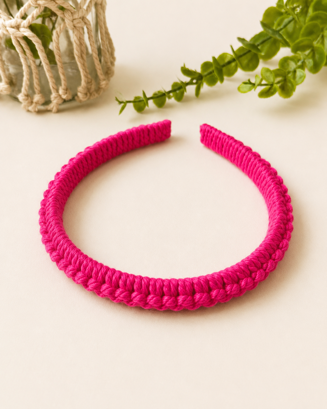 Fuchsia handmade macramé headband crafted with cotton cord.