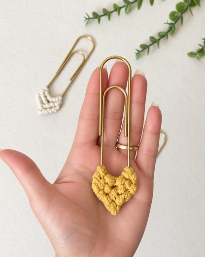Back view of handmade mustard macramé heart bookmark with gold paper clip