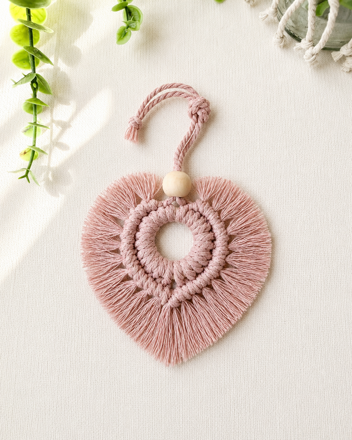 Blush pink macrame heart car charm with fringe and wooden bead, handmade boho rear view mirror charm.