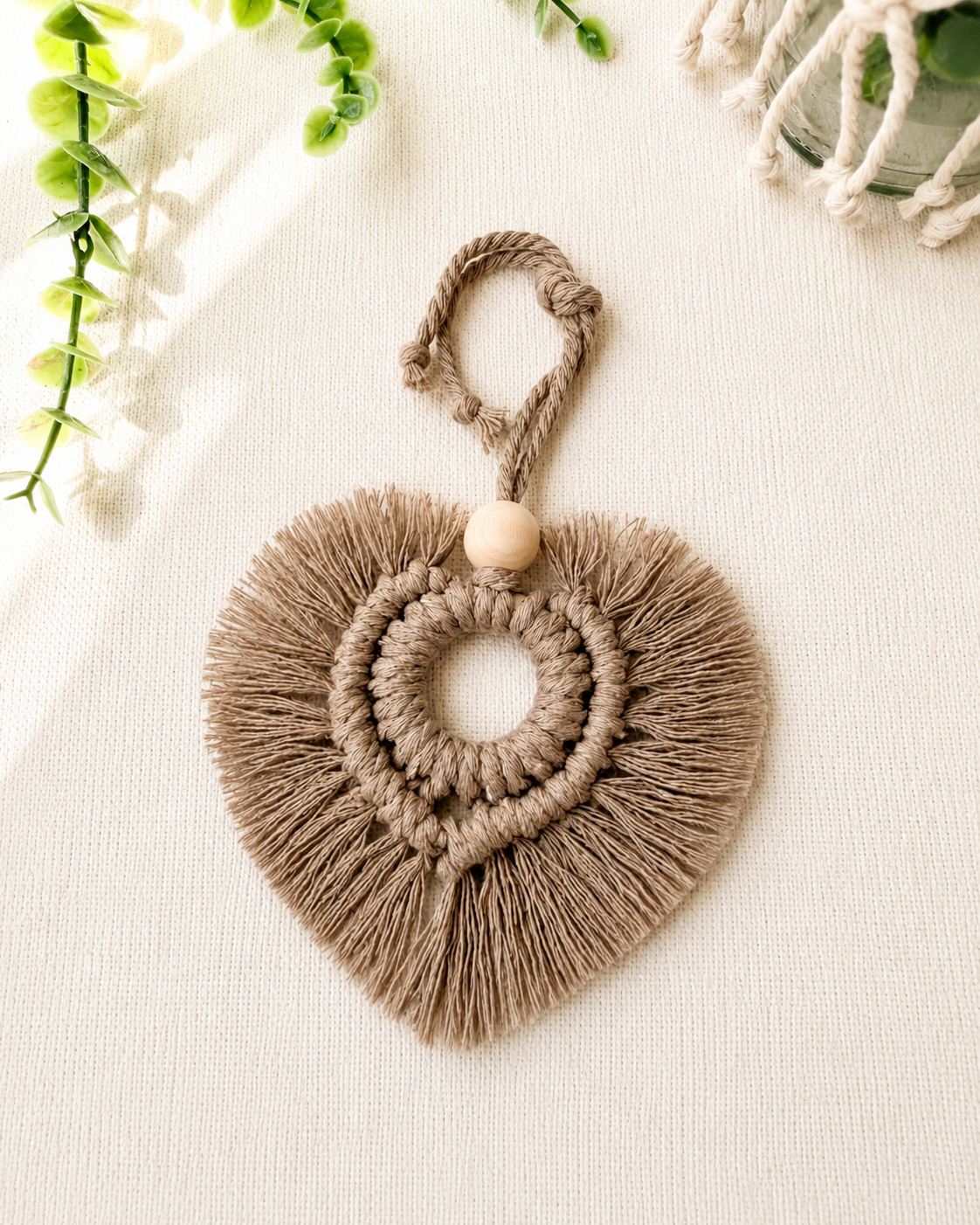 Taupe macrame heart car charm with fringe and wooden bead, handmade boho rear view mirror charm.