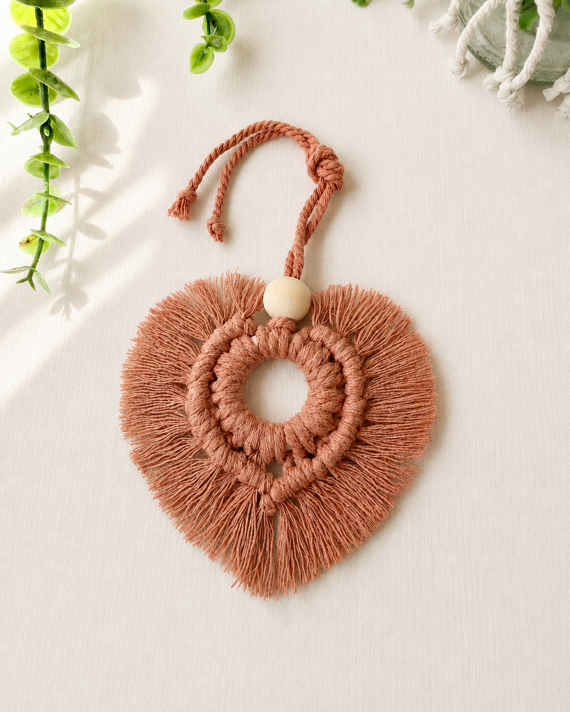 Terracotta macrame heart car charm with fringe and wooden bead, handmade boho rear view mirror charm.