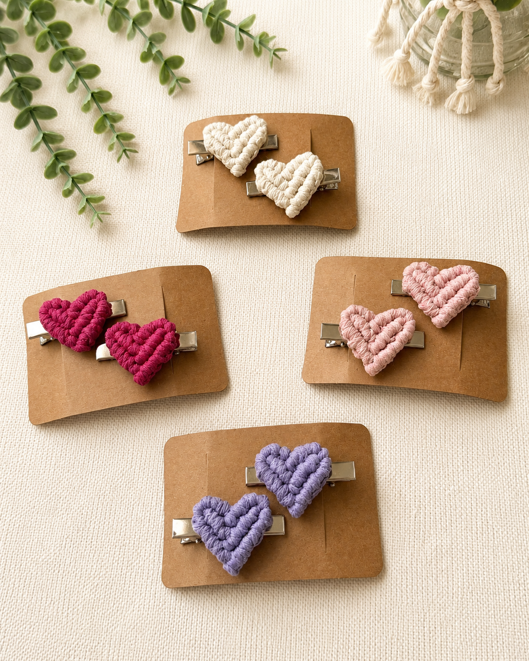 Handmade macrame heart hair clips presented on kraft display cards in four colour options.