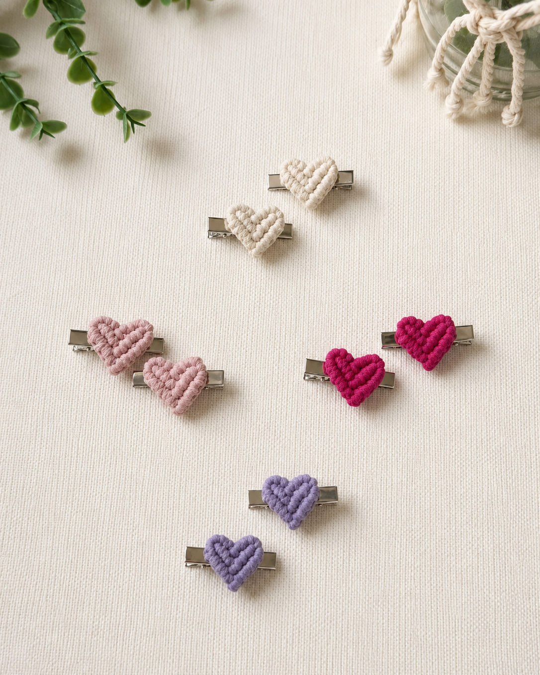 Set of two handmade macrame heart hair clips in natural, blush pink, lilac and fuchsia cotton.