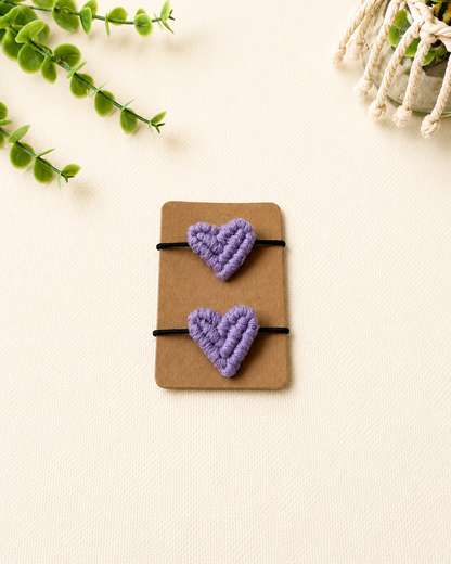 Handmade lilac macrame heart hair ties on black elastic ponytail holders.