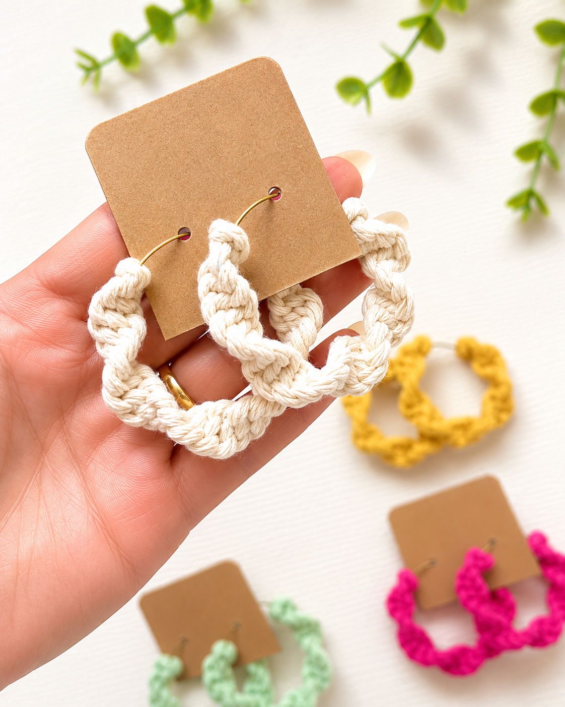 Handmade macramé hoop earrings displayed on jewellery cards in various colours
