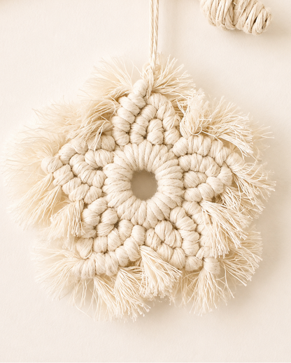 Handmade macrame flower ornament hanging inside crescent moon wall decor